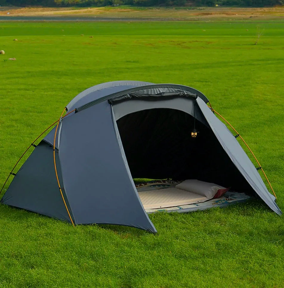 Unisex 2-person camping tent set up outdoors, ideal for backpacking and hiking adventures.