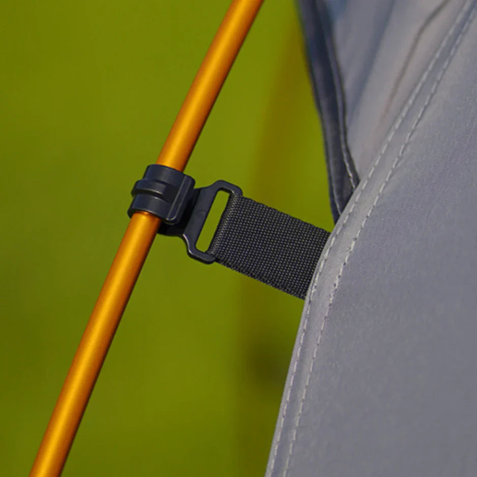Backpacking tent for two, collapsed and packed, showing its compact size for hiking portability.