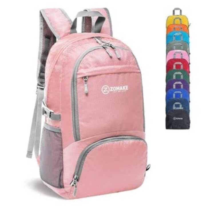 Group of packable backpacks stacked, showing variety of colors, essential for travel & hiking.