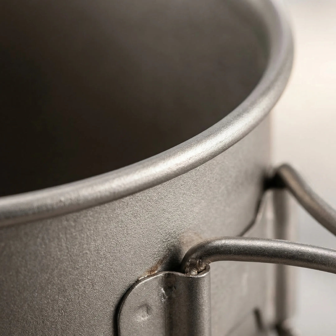 Unisex titanium camping cookware set, ready for outdoor meals. Essential lightweight gear for backpacking trips.