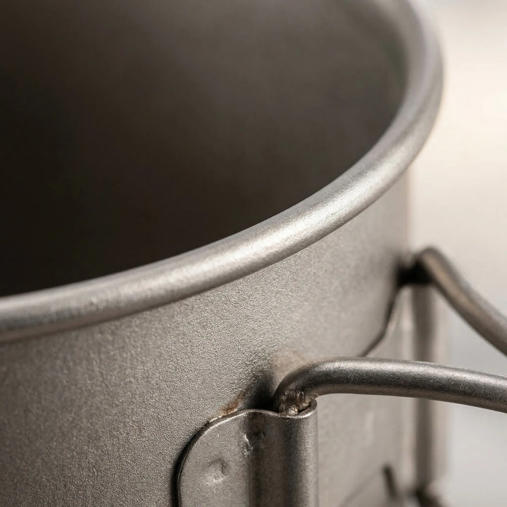 Unisex titanium camping cookware set, ready for outdoor meals. Essential lightweight gear for backpacking trips.