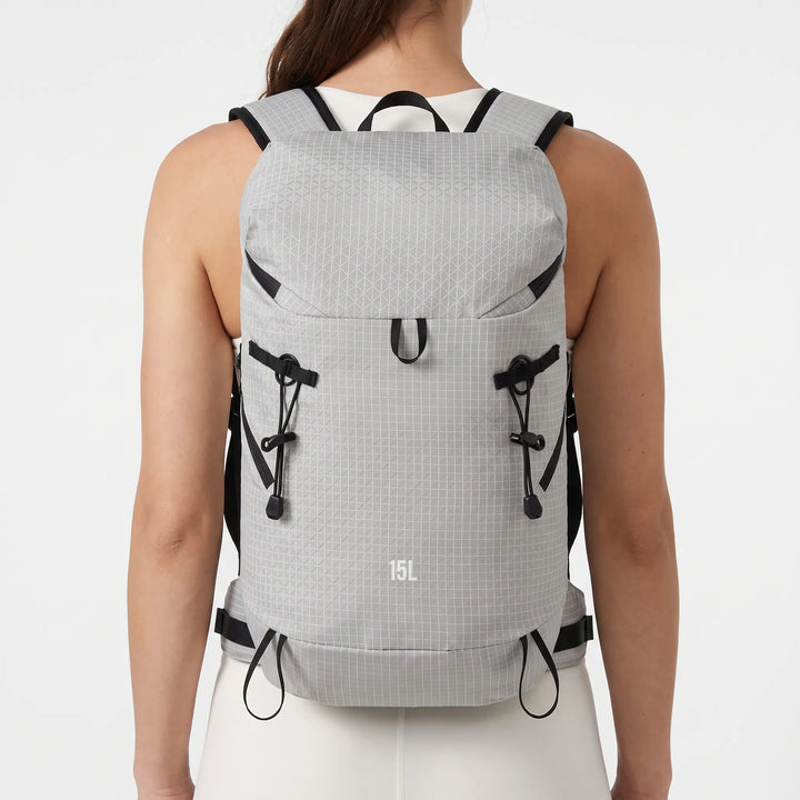 Unisex lightweight hydration backpack with multiple pockets for essential outdoor gear on trails.