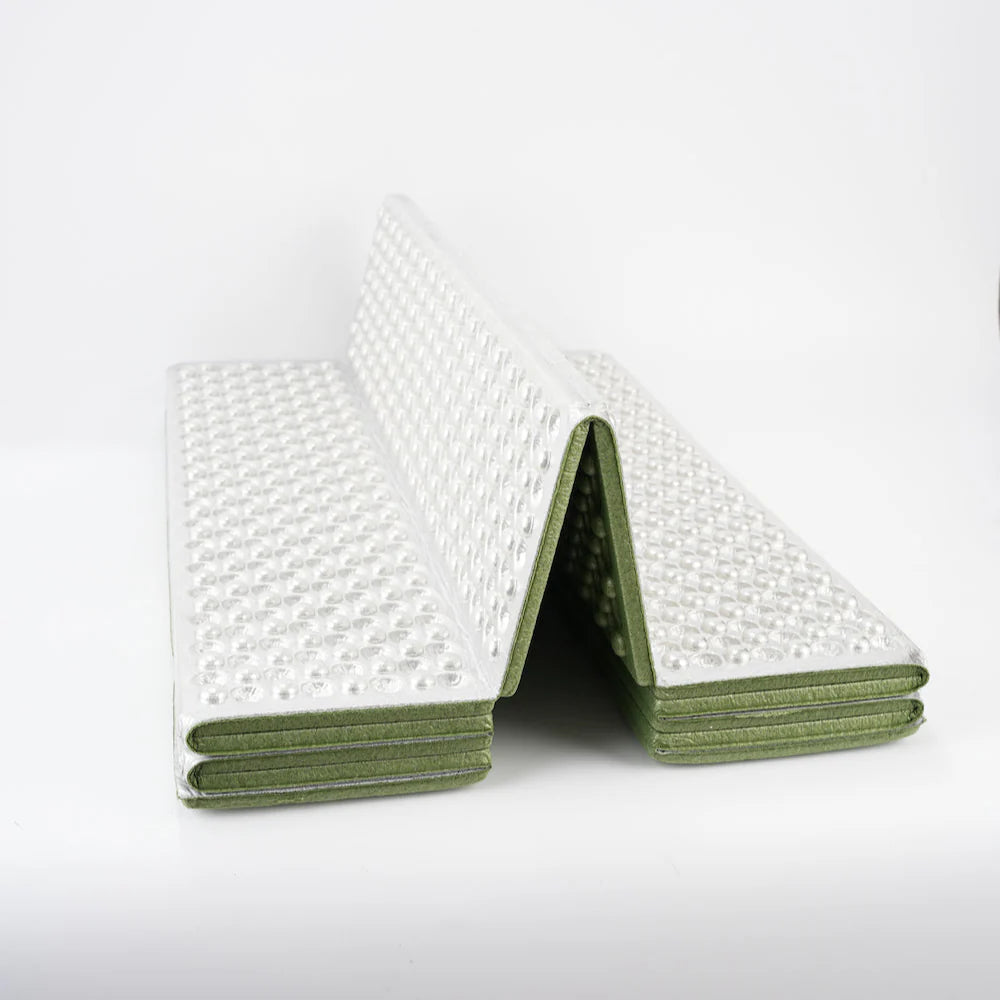 Unisex thermal sleeping pad in an outdoor camping shelter, showcasing its compact size
