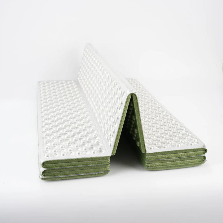 Unisex thermal sleeping pad in an outdoor camping shelter, showcasing its compact size