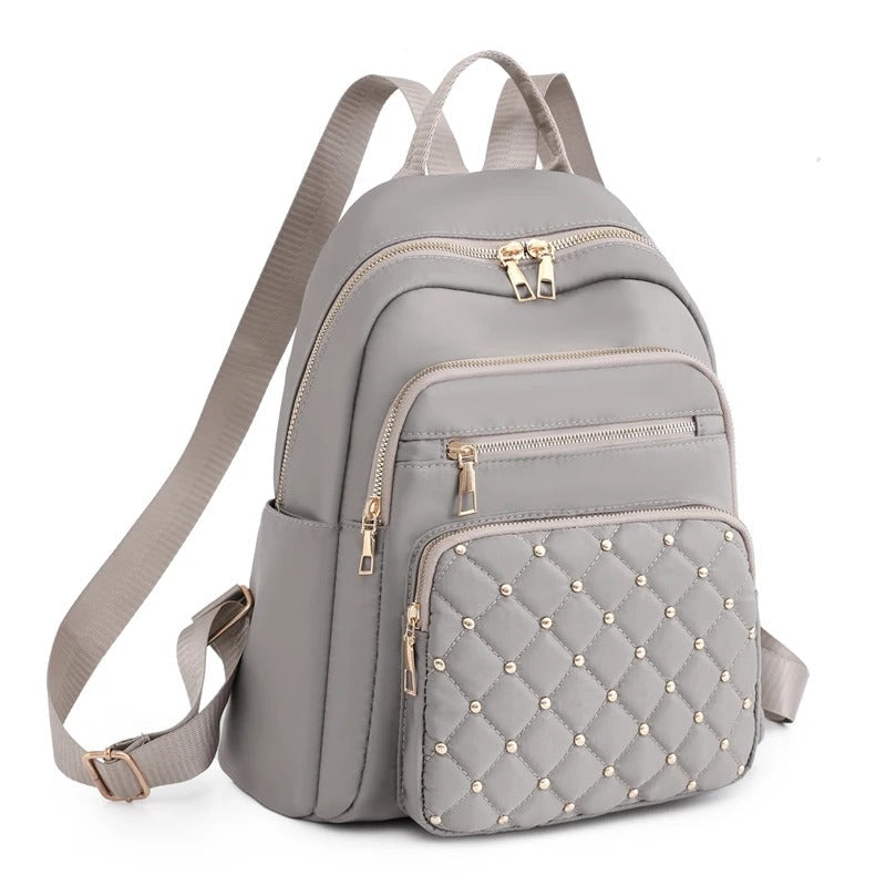 Black lightweight water-resistant nylon backpack for women, perfect for commuting & travel.
