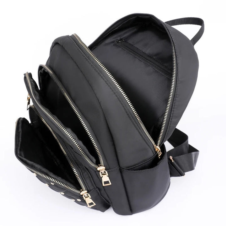 Durable water-resistant nylon travel backpack for women, lightweight for comfortable journeys.