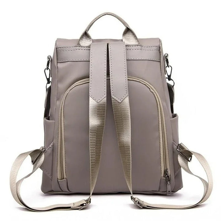 Close-up of durable, water-resistant nylon on a women's multi-way backpack. Lightweight & easy to clean travel bag.