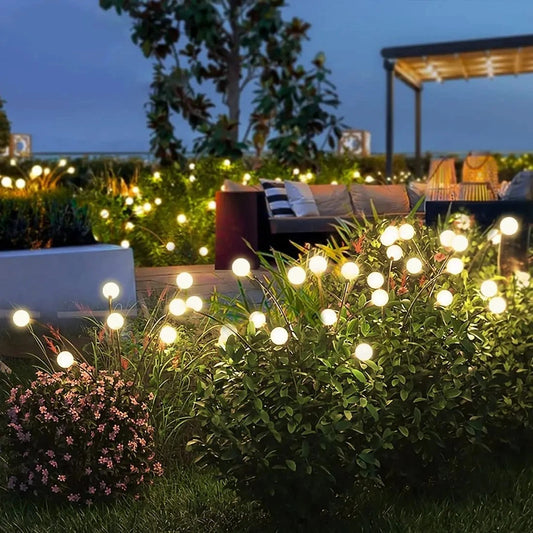 "Luci solari da giardino con steli flessibili, illuminazione dorata calda, perfette per un'atmosfera esterna incantevole."