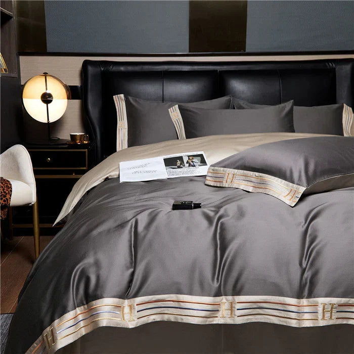 Luxurious embroidered satin cotton bedding set on a queen bed, creating an elegant bedroom ambiance.