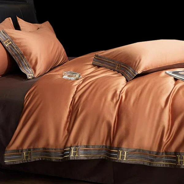Detailed shot of a corner on the embroidered satin cotton duvet cover, showing superior stitching quality.