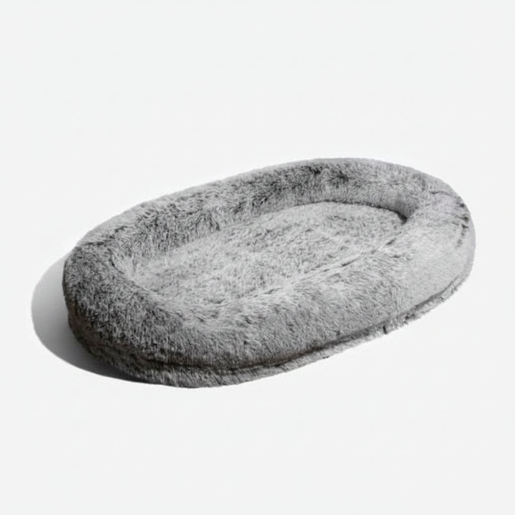 Oversized shared calming pet bed for humans & pets. Plush, machine washable faux fur provides ultimate comfort.