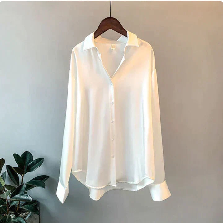 Chic women's luxurious long sleeve button-up shirt. Relaxed fit blouse with elegant style for any occasion.