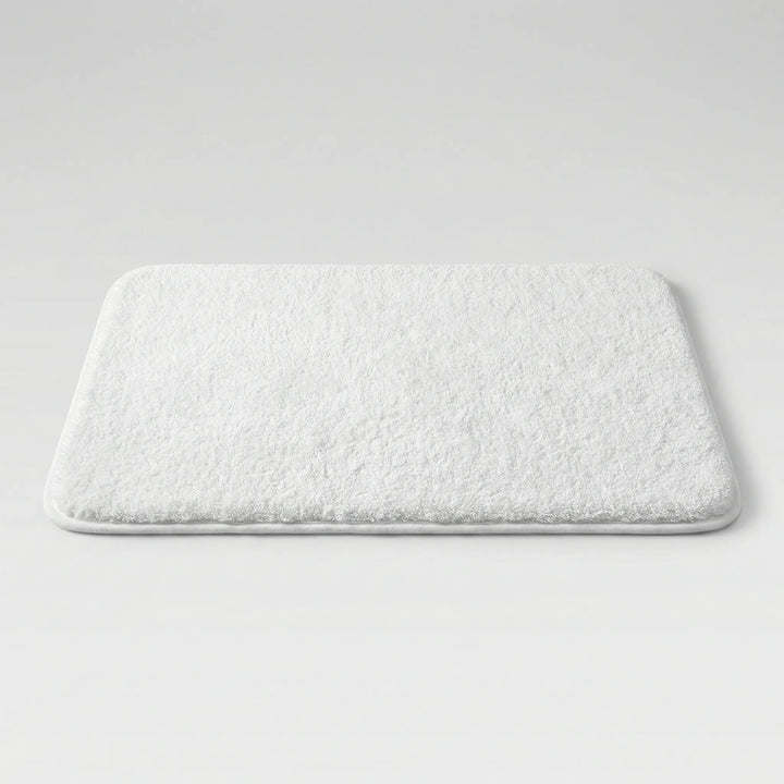 Soft, non-slip Flowique bath mat featuring a stylish wave pattern. Ideal for luxurious bathroom decor.