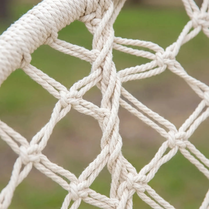 Indoor/Outdoor Macrame Hammock Chair. Durable cotton rope swing for patio, balcony, or living room relaxation.