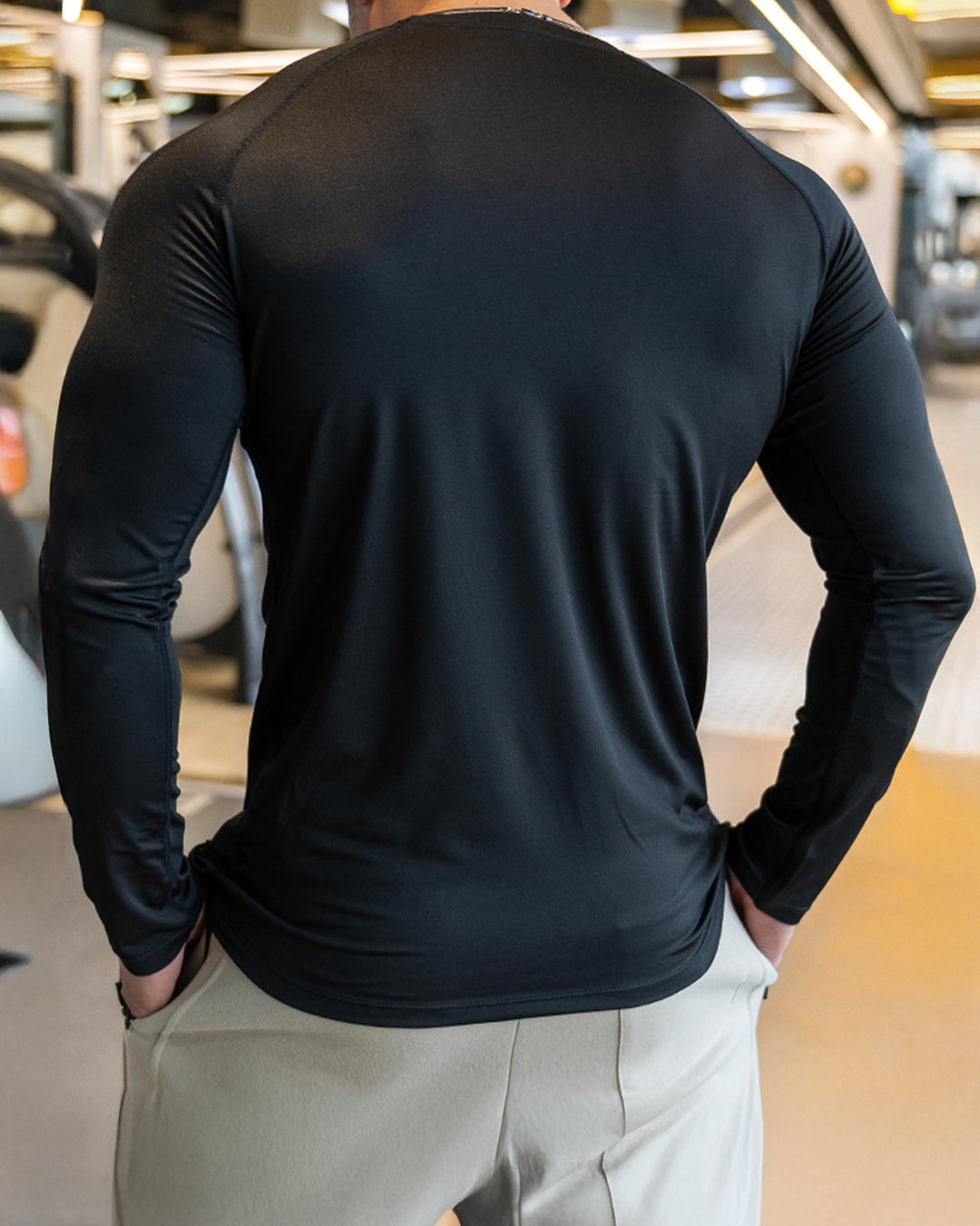 Performance men's long sleeve top, shoulder cut, ideal for fitness and activewear.