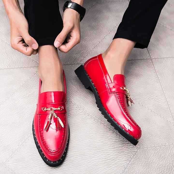 Men's shiny black patent loafers with tassels, perfect slip-on dress shoes for a bold and elegant formal look.