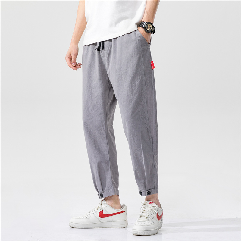 Relaxed fit linen blend men's trousers in gray with adjustable cuffs, ideal breathable summer pants.