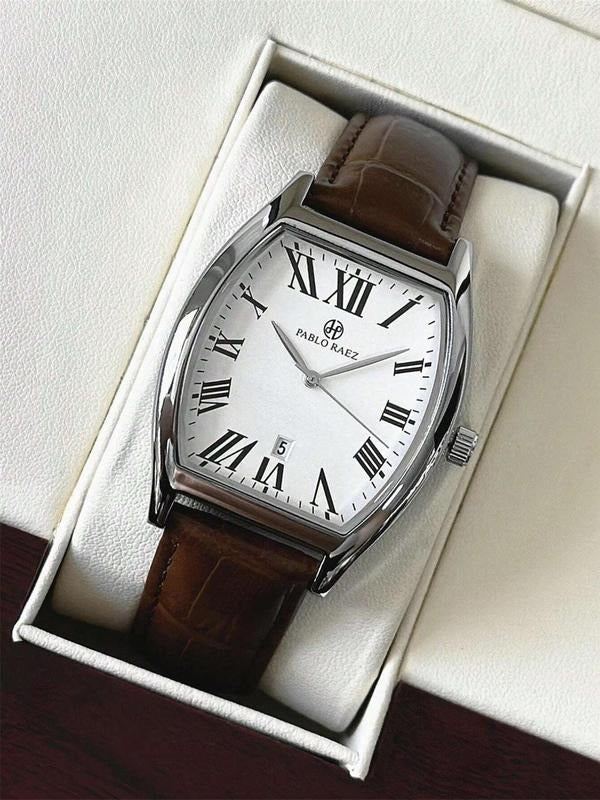 Men's formal analog watch on wrist, paired with a business suit, emphasizing timeless elegance.