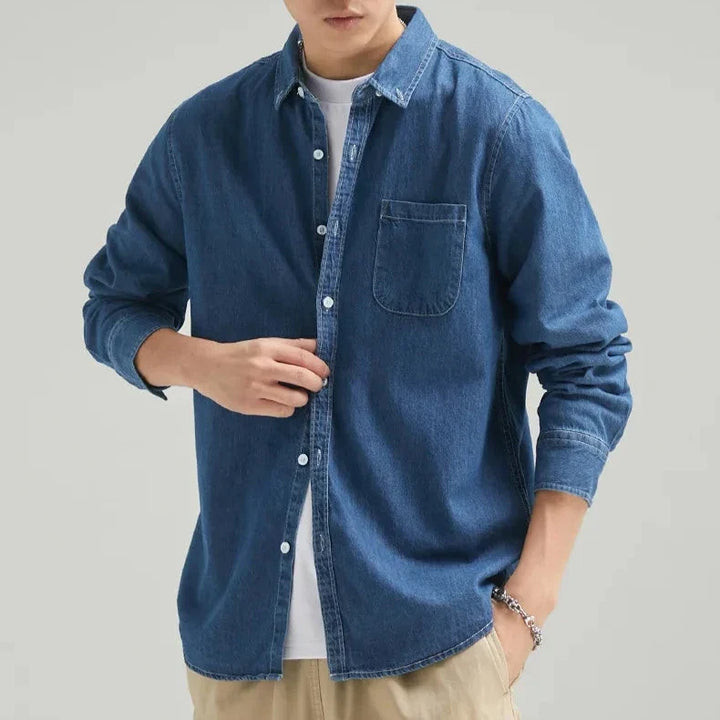 Comfortable men's blue denim shirt. Classic fit, long sleeve button-up for effortless casual style.
