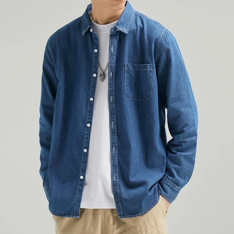 Versatile men's blue denim button-up shirt. Timeless long sleeve design for classic casual wear.