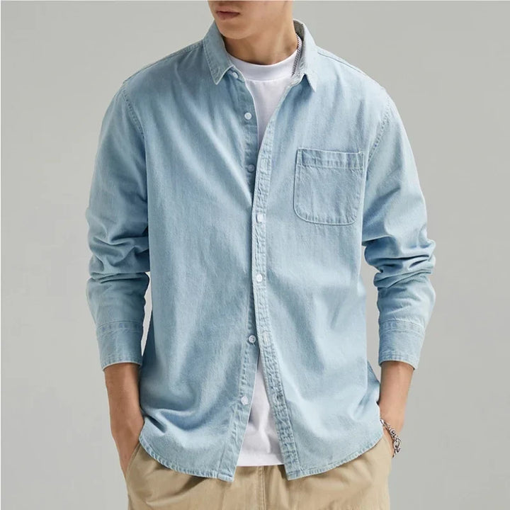 Men's classic black denim button-up shirt. Long sleeve, casual fit for versatile everyday wear.