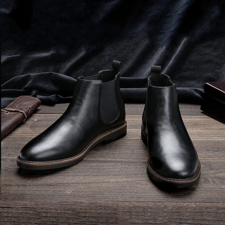 Men's stylish Chelsea boots paired with denim jeans, showcasing a perfect casual look.