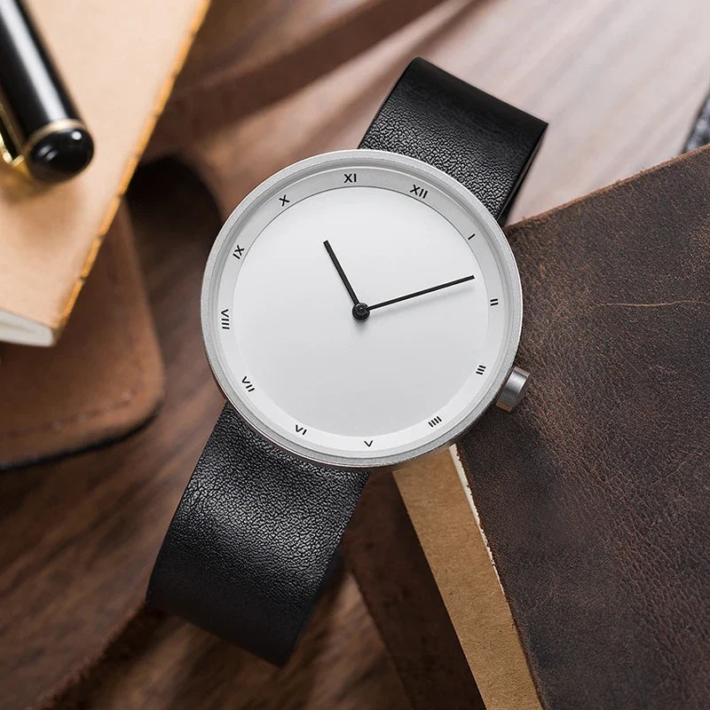 Close-up of a men's classic wrist watch, featuring a minimalist dial and a sophisticated brown leather strap.