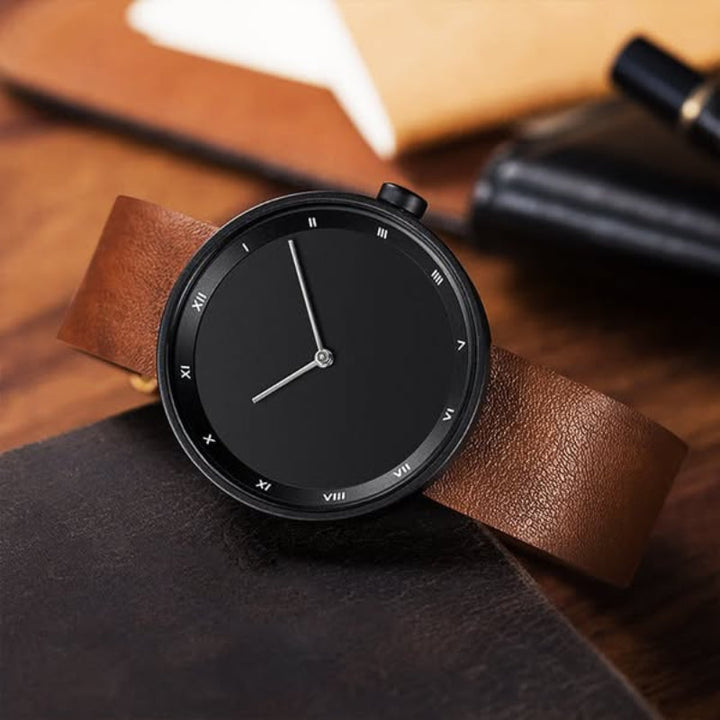 Elegant men's classic leather wristwatch with a polished case and a simple, easy-to-read dial.