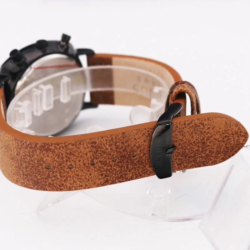 Side view of durable men's chronograph watch. Features a rich brown leather strap and polished stainless steel case.