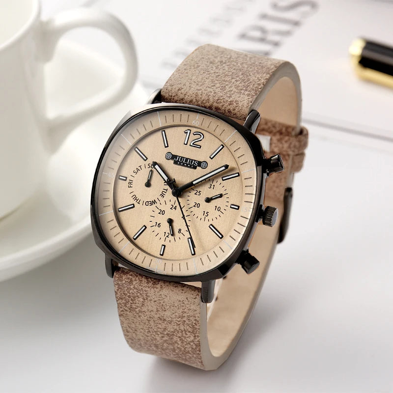 Elegant men's accessories: a classic chronograph watch with a sophisticated black leather strap and polished finish.