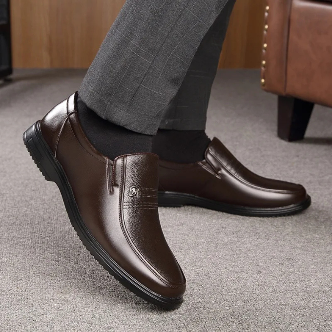 Professional men's black slip-on dress shoes, designed for comfort and a sharp, formal appearance.