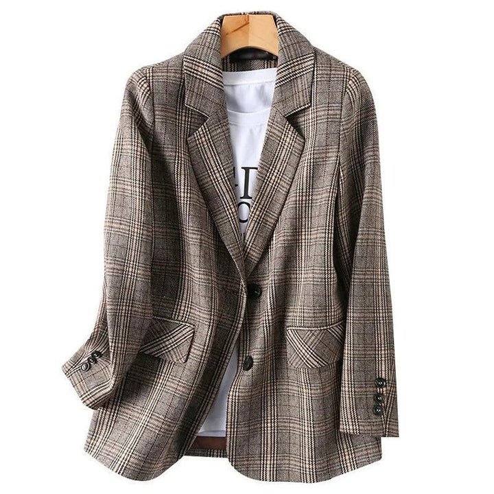 Man wearing a classic tailored plaid blazer, showcasing a smart, professional, and stylish business casual look.