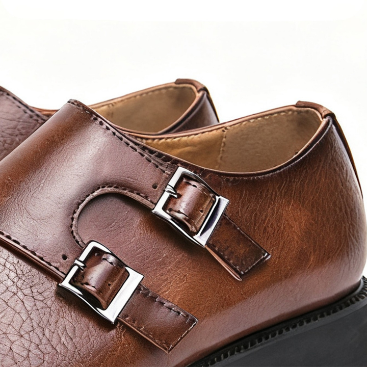 Close-up of the polished double buckles on black Valmont men's dress loafers. Formal & stylish.