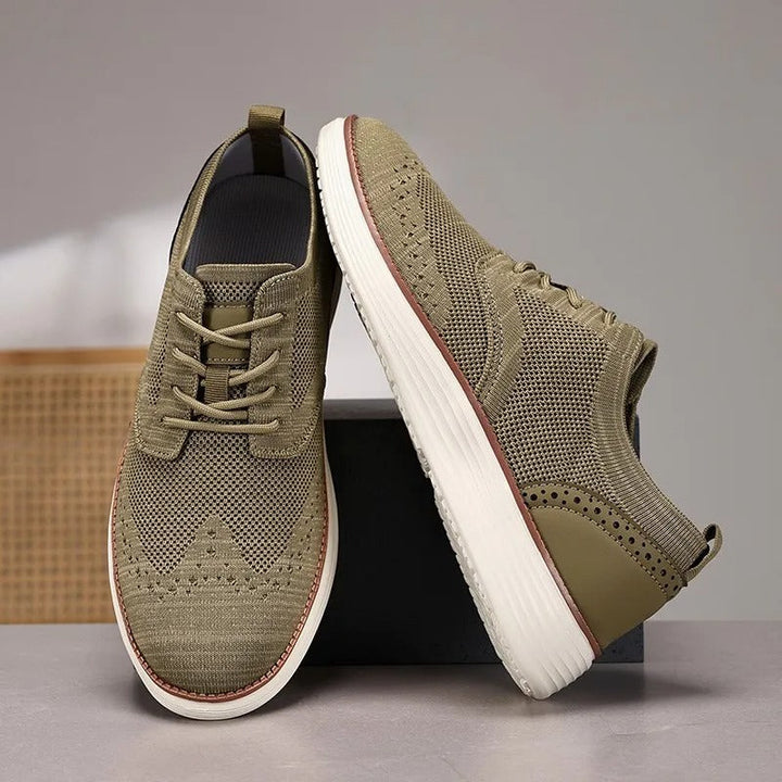Front view of men's comfort dress sneakers with detailed wingtip design. Perfect for versatile wear.