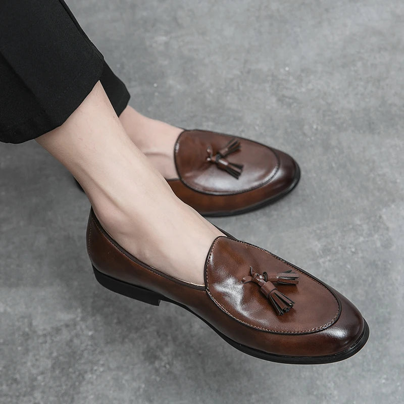 Close-up of men's crescent tassel loafers, highlighting the detailed stitching and elegant tassels.