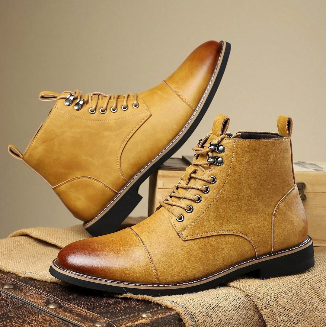 Back view of men's outdoor boots, highlighting solid heel and traction grip pattern on the rugged sole.