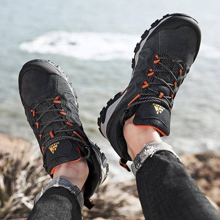Side view of men's lace-up outdoor boots, showing deep tread for excellent grip on trails