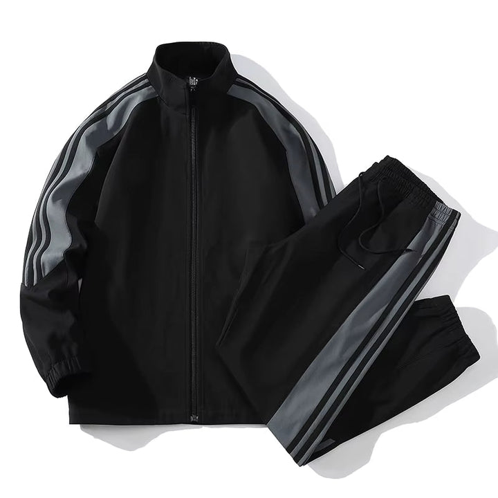 Performance men's color-block activewear tracksuit. Includes a dynamic zip-up jacket and jogger pants for athletic use.