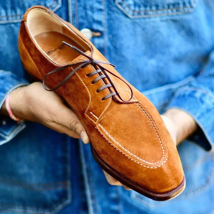 Sleek side profile of men's classic brown leather oxfords, offering refined style and versatile formal footwear.