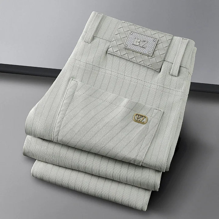 Stylish man wearing elegant striped business trousers, showcasing a professional yet comfortable office look.