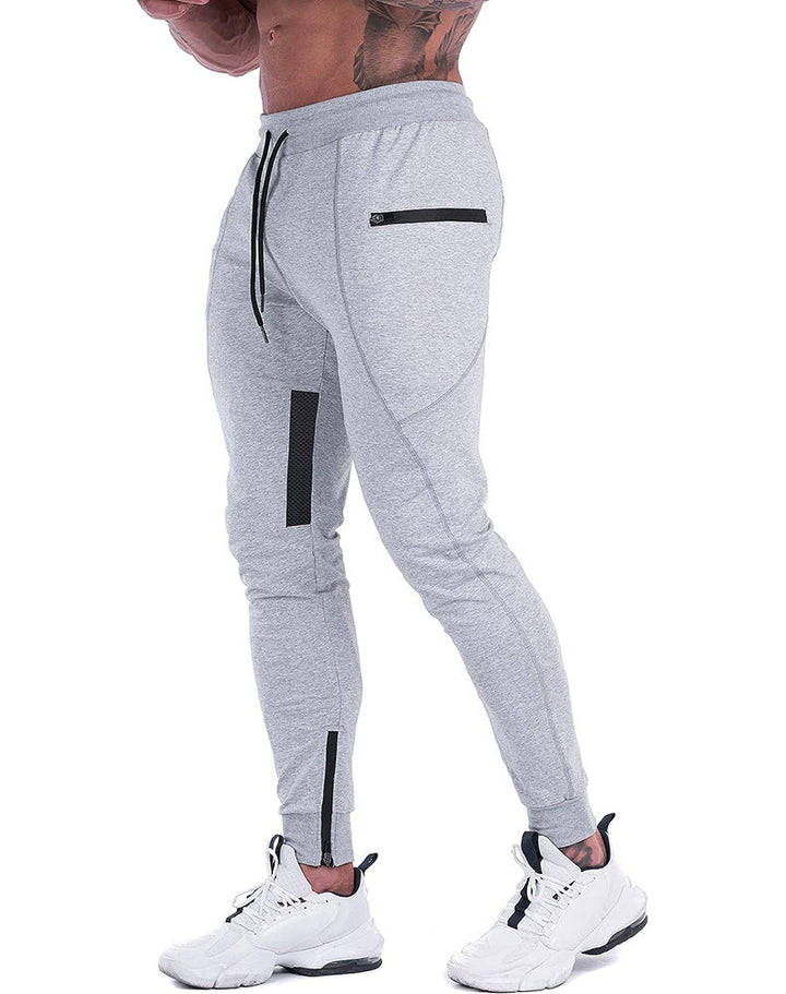 Man modeling men's everyday comfort tapered joggers, highlighting drawstring and fit.