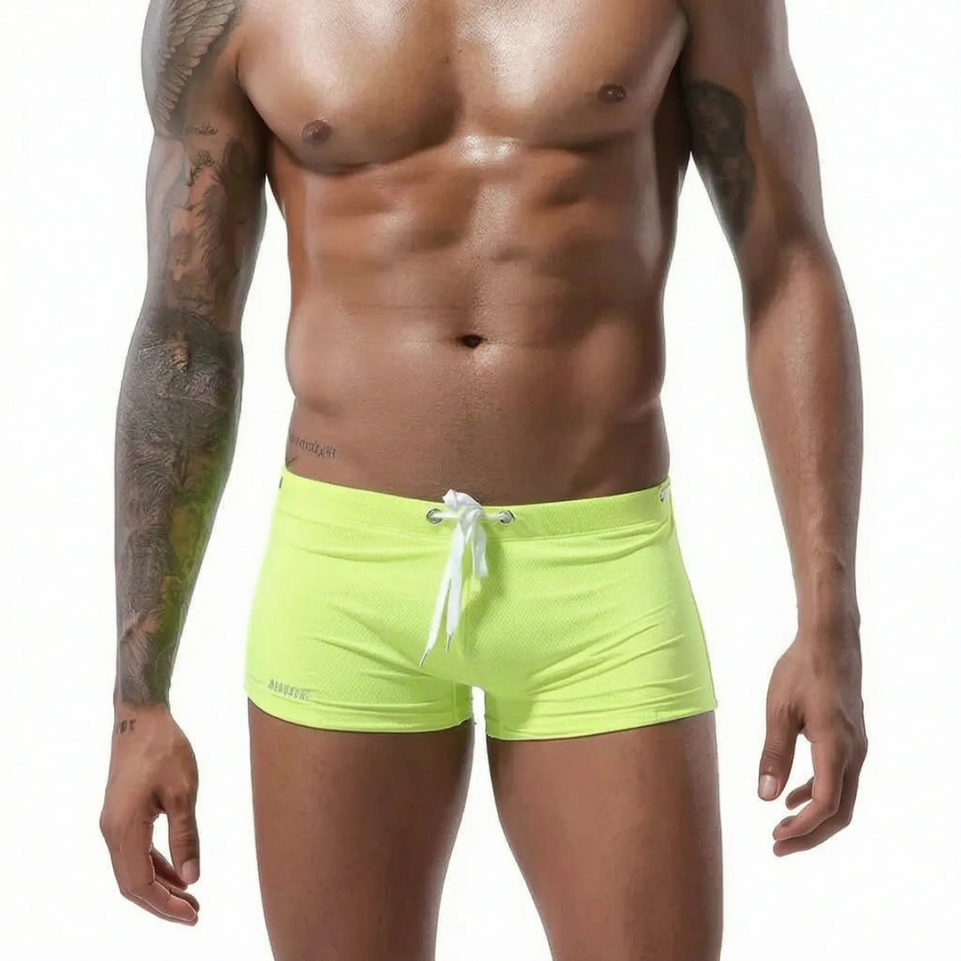Modern men's low-rise fitted swim trunks, short cut design for active comfort & quick drying.