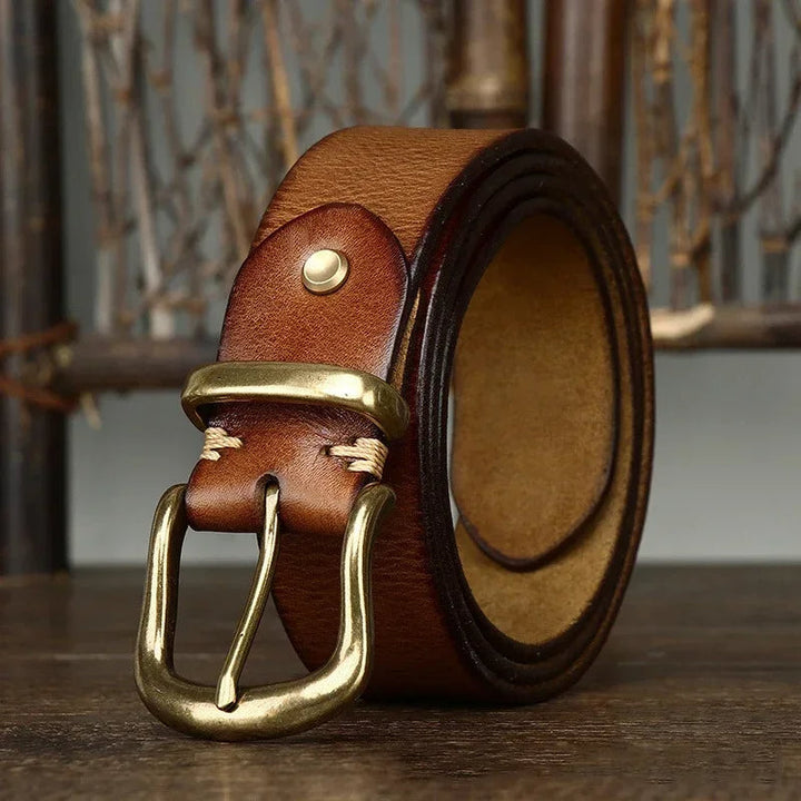 Full-grain leather belt for men, featuring a polished brass buckle, embodying timeless men's style.