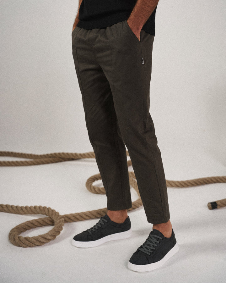 Side view of men's tapered pants, highlighting the modern tapered leg & relaxed fit for comfort & style.