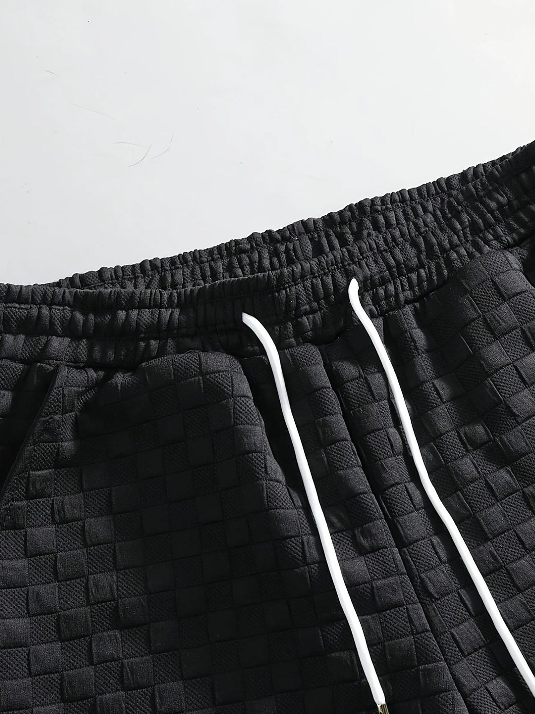 Man wearing a relaxed gridline checkered lounge set, showcasing comfortable two-piece homewear for summer.