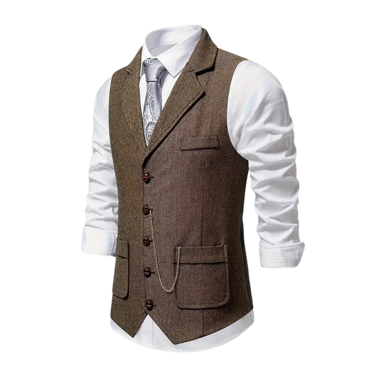 Man wearing a stylish herringbone waistcoat over a shirt, showcasing a sophisticated layered look.