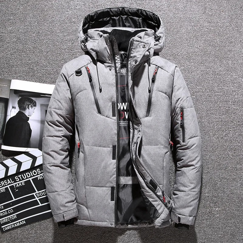 Warm men's hooded puffer jacket. Insulated winter coat designed for robust all-weather outdoor adventures.