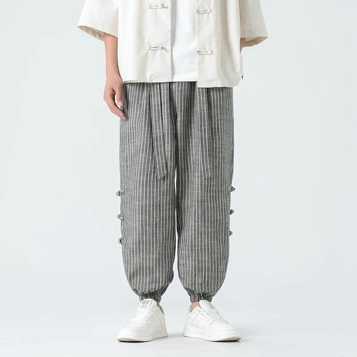 Gray men's Japanese streetwear pants, loose fit, side stripe design for urban trendsetters.