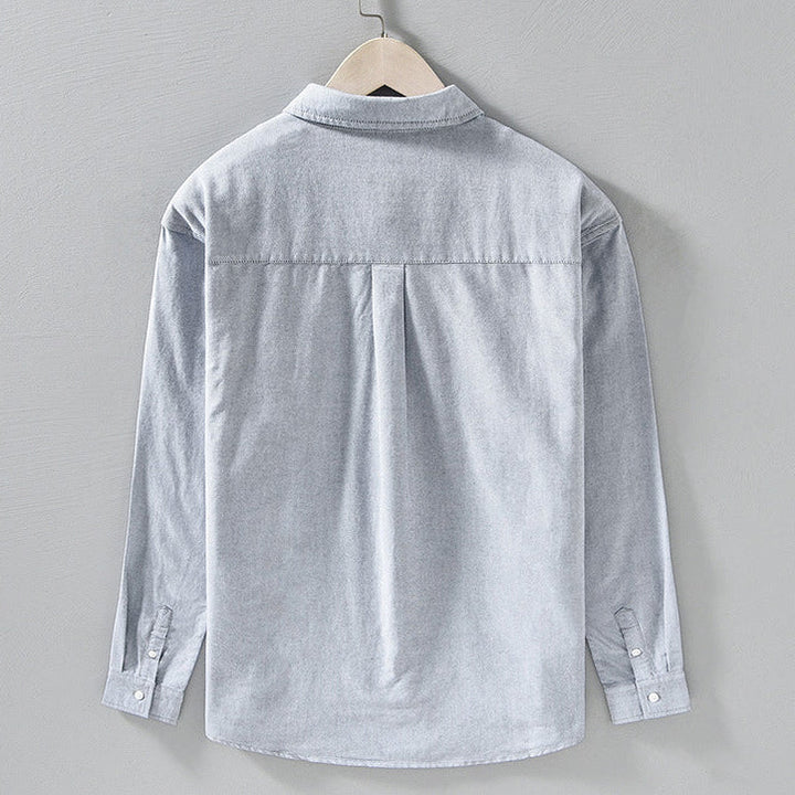 Close-up of Julian men's button-front shirt, showcasing the stylish striped placket and classic long sleeves.
