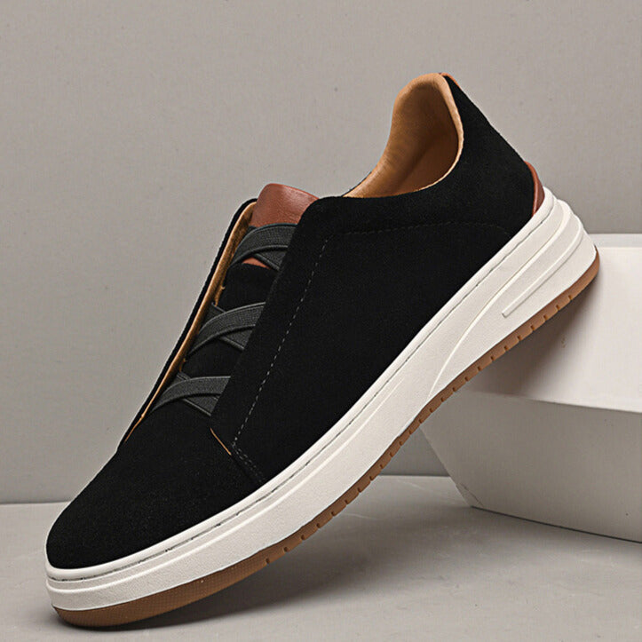 Black slip-on sneakers for men, refined & versatile everyday footwear.